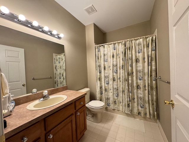 bathroom with tile patterned flooring, toilet, vanity, and visible vents