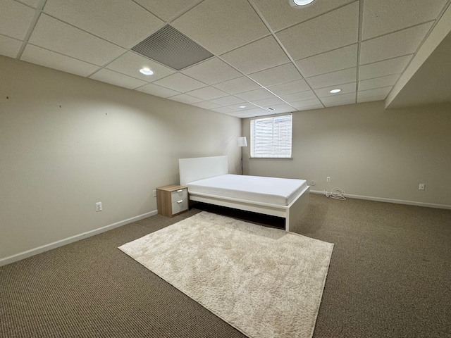 unfurnished bedroom with visible vents, baseboards, carpet, a drop ceiling, and recessed lighting