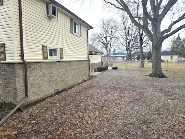 view of yard featuring gravel driveway and fence