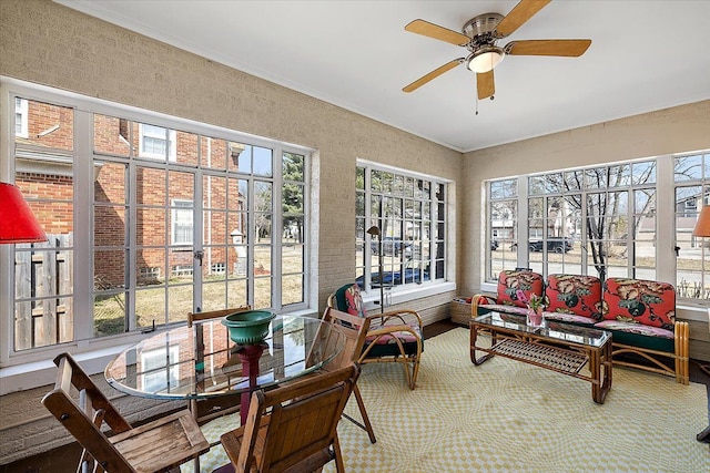 sunroom featuring a ceiling fan