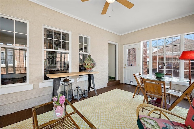 sunroom featuring ceiling fan