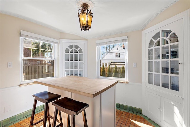 dining space with brick floor and an inviting chandelier