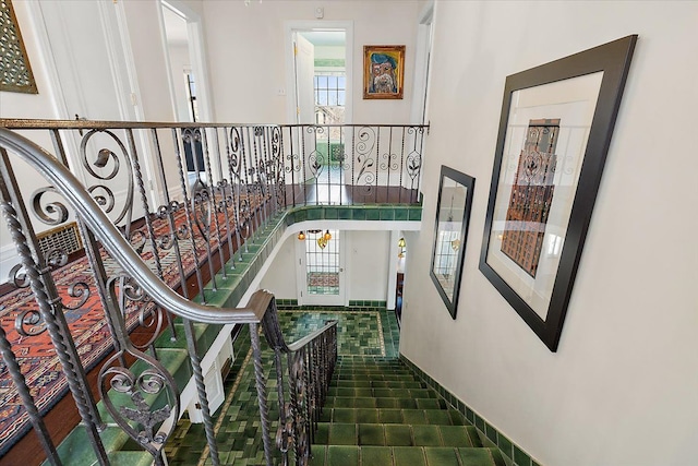 stairs with tile patterned floors and plenty of natural light