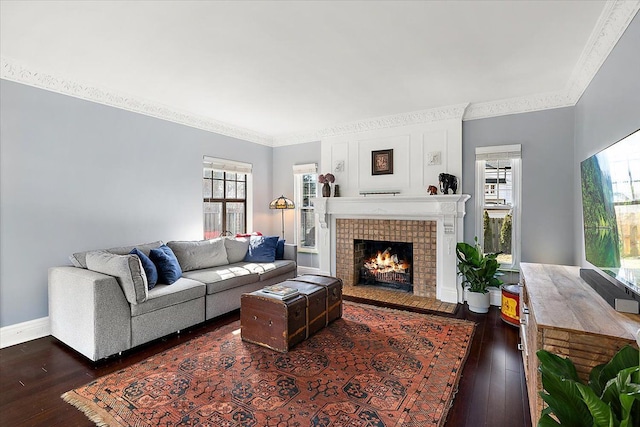 living area featuring plenty of natural light, ornamental molding, baseboards, and hardwood / wood-style flooring