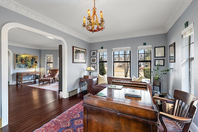 office space featuring crown molding, baseboards, wood finished floors, arched walkways, and a notable chandelier