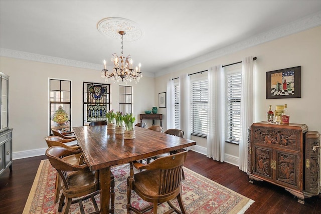 dining area featuring dark wood-type flooring, crown molding, baseboards, and a chandelier