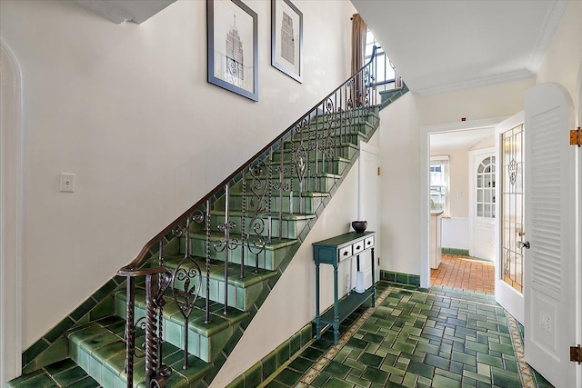 staircase featuring baseboards and ornamental molding