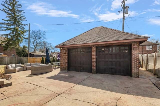 detached garage featuring fence