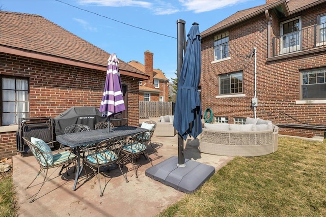 view of patio / terrace featuring outdoor dining space, fence, and grilling area