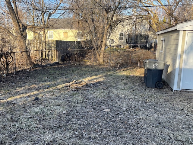 view of yard featuring an outdoor structure and fence