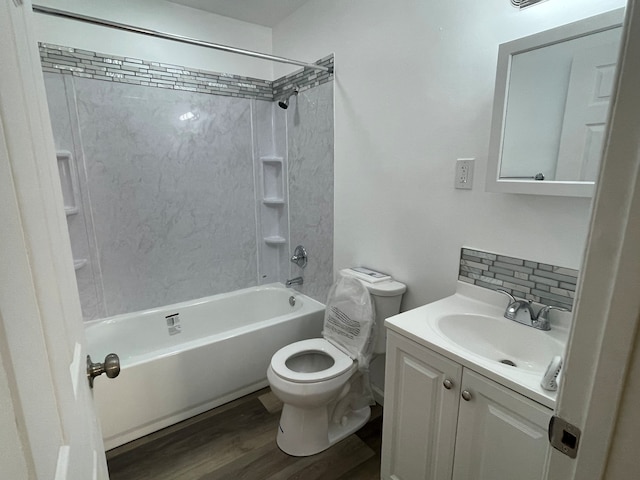 full bath featuring toilet, decorative backsplash, bathtub / shower combination, wood finished floors, and vanity