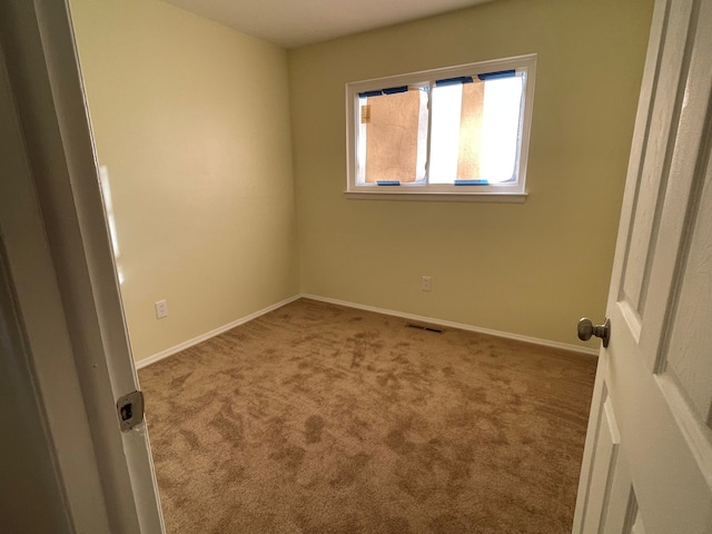 unfurnished bedroom featuring visible vents, baseboards, and carpet floors