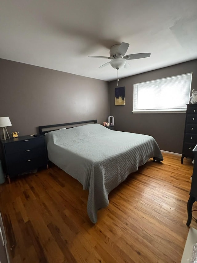 bedroom with wood finished floors and a ceiling fan