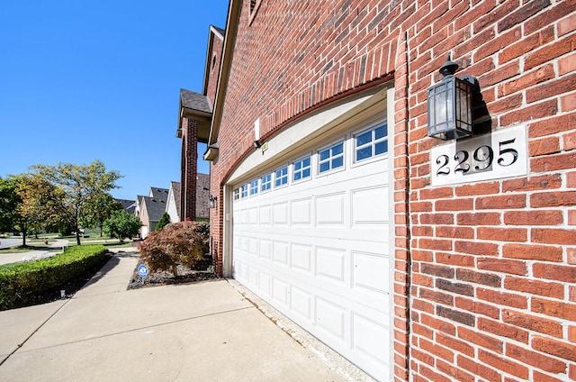 garage featuring concrete driveway