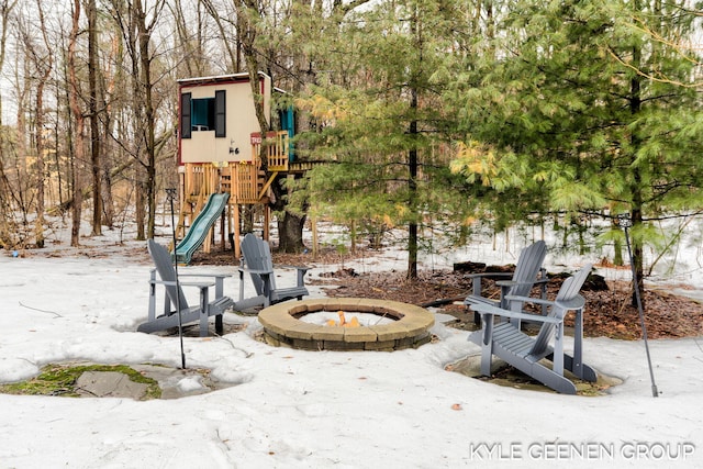 view of patio / terrace with an outdoor fire pit and a playground