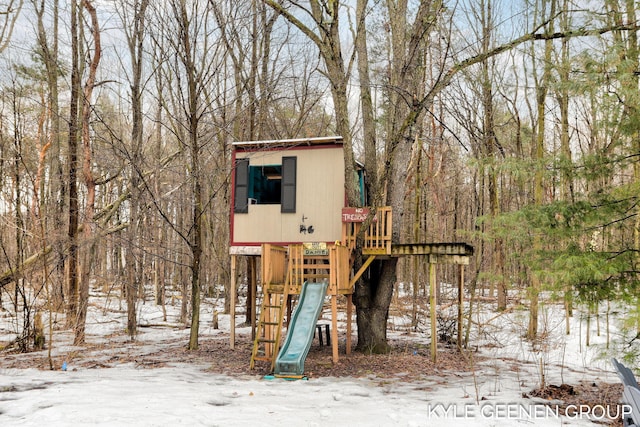 snow covered structure with a playground