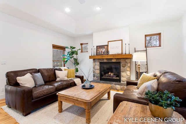 living room with light wood-type flooring, a fireplace, and recessed lighting