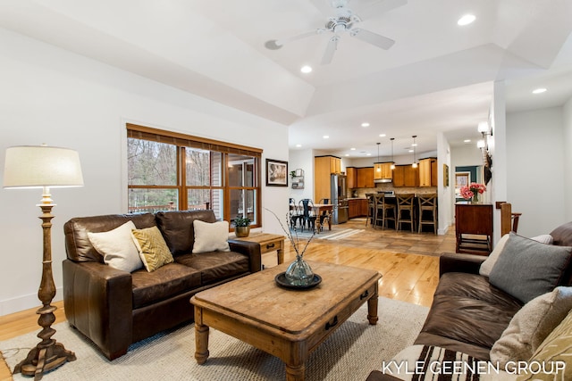 living area featuring ceiling fan, baseboards, light wood-style flooring, and recessed lighting