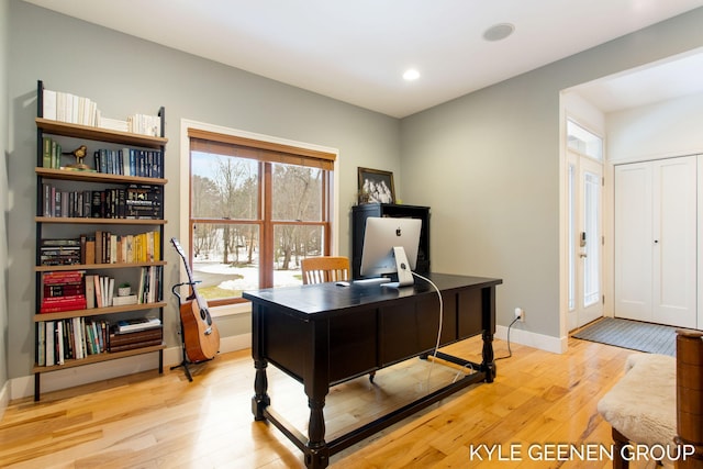 home office featuring light wood finished floors, baseboards, and recessed lighting