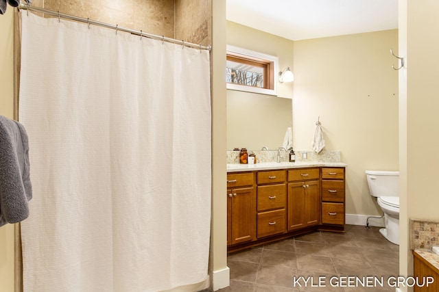 bathroom with tile patterned flooring, curtained shower, vanity, and toilet