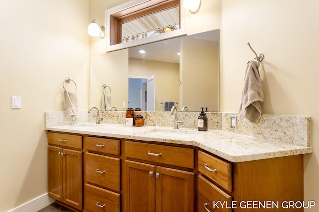 bathroom featuring double vanity and a sink