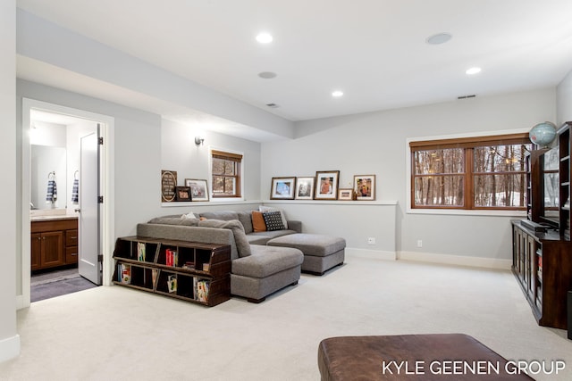 living area featuring carpet, baseboards, and recessed lighting