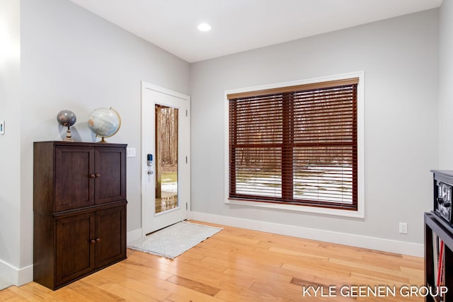 entryway featuring light wood-type flooring, baseboards, and recessed lighting