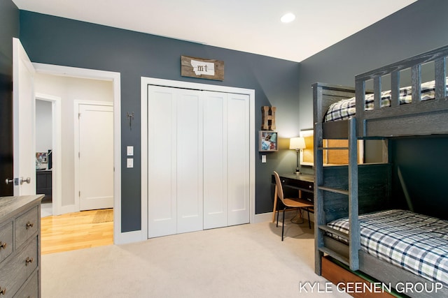 bedroom with recessed lighting, a closet, light carpet, and baseboards