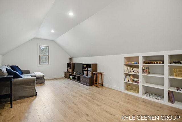 sitting room with lofted ceiling, baseboards, and wood finished floors