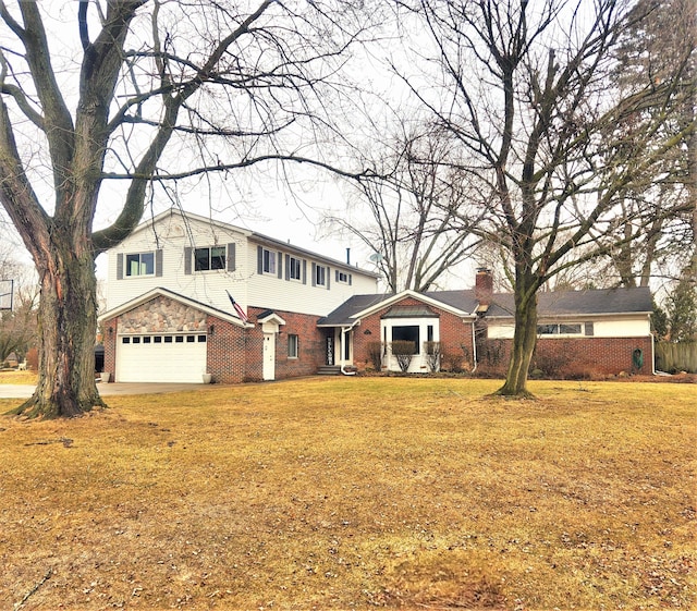 view of front of house with a front yard, brick siding, a chimney, and an attached garage