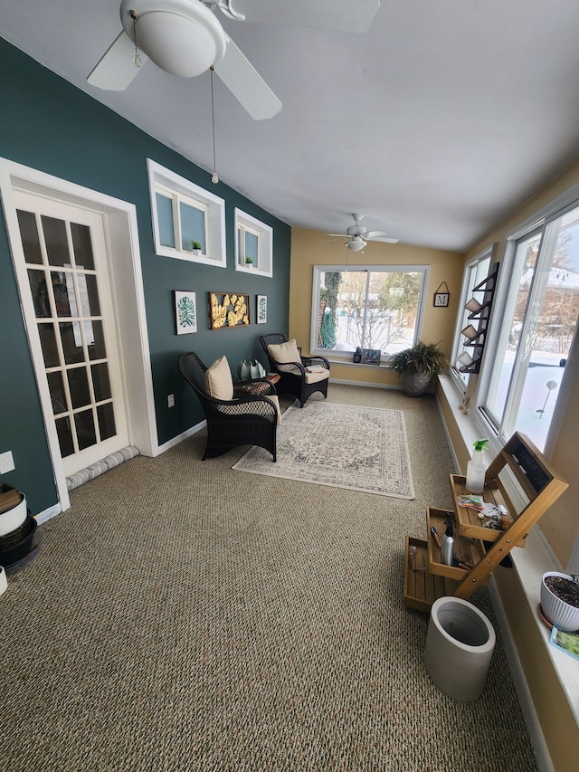 carpeted living room with a ceiling fan and baseboards