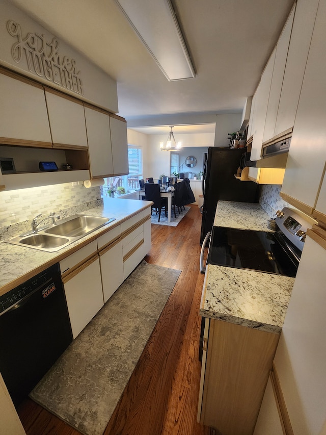 kitchen with light countertops, white cabinetry, a sink, wood finished floors, and black appliances