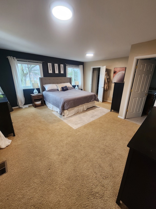 carpeted bedroom featuring visible vents and baseboards