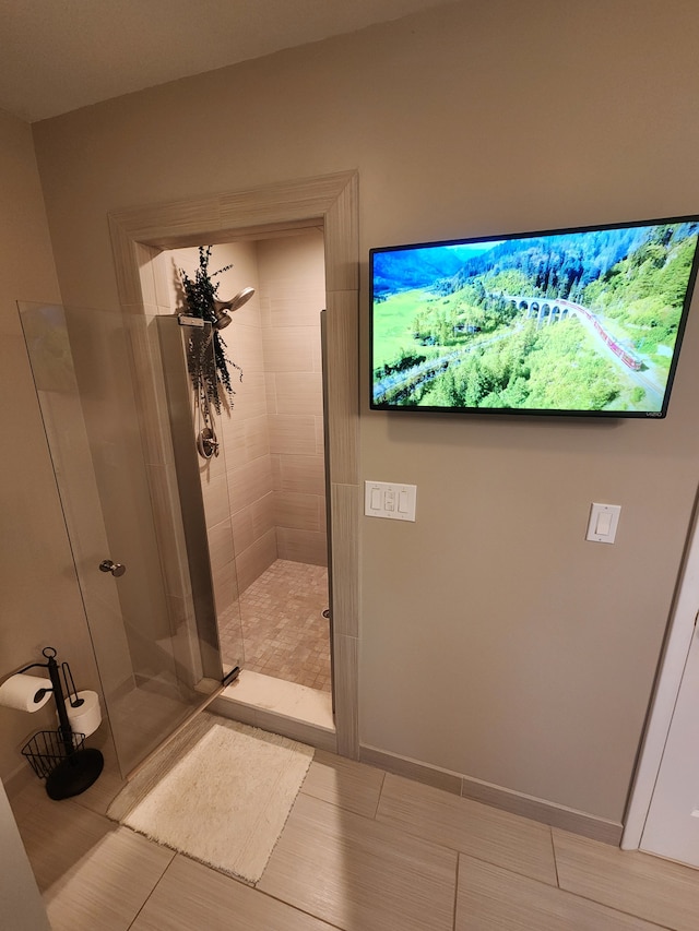 full bath with baseboards, a stall shower, and tile patterned floors