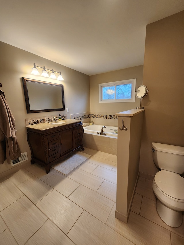 bathroom with visible vents, toilet, vanity, baseboards, and a bath