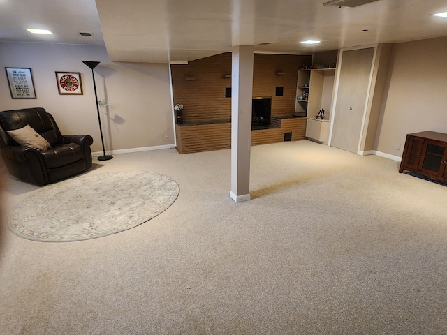 finished basement featuring light carpet, visible vents, and baseboards