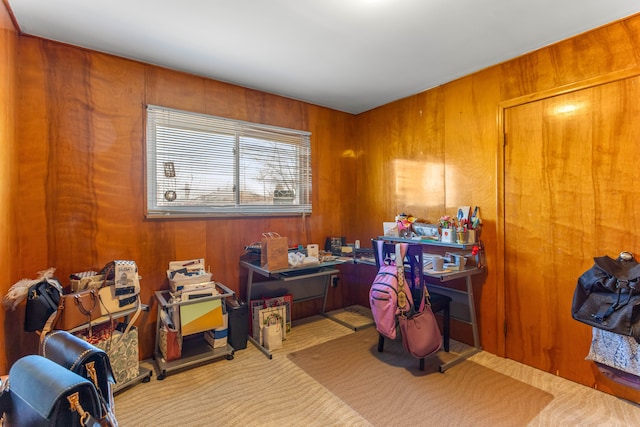 carpeted home office with wooden walls