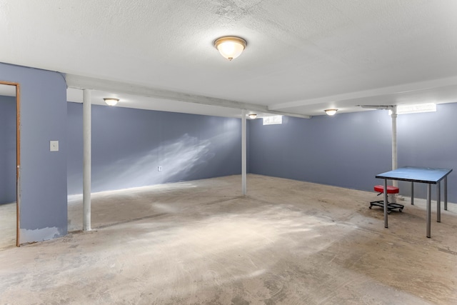 basement featuring a textured ceiling