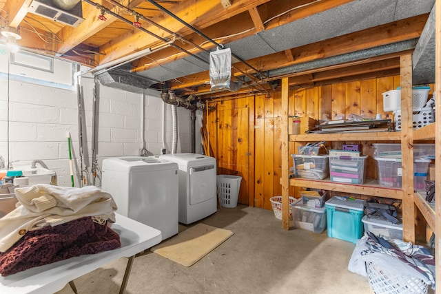 basement with visible vents and washer and dryer