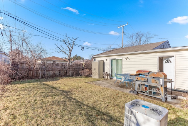 view of yard with fence, cooling unit, and a patio