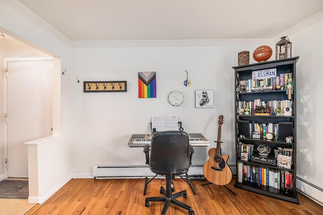 office area with a baseboard radiator, baseboards, and wood finished floors