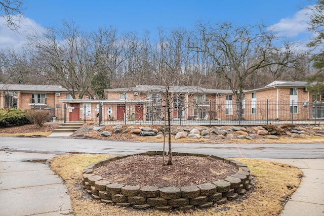 view of front facade with a fenced front yard and a residential view