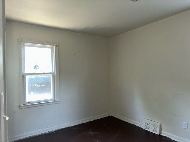 unfurnished room with visible vents and baseboards