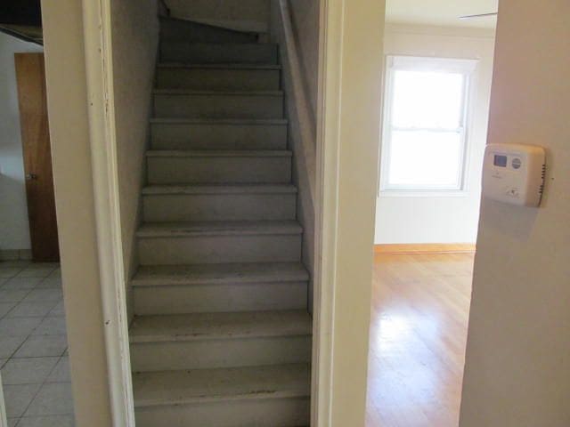 stairs with tile patterned flooring