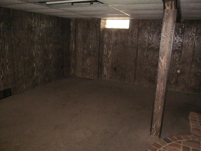 below grade area featuring a paneled ceiling and visible vents