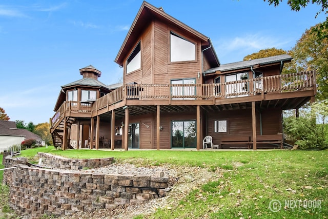 rear view of property featuring stairway, a lawn, a deck, and a gazebo