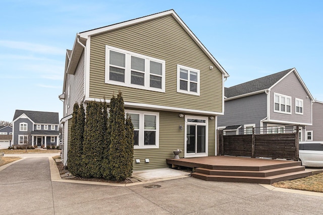 back of property featuring a wooden deck