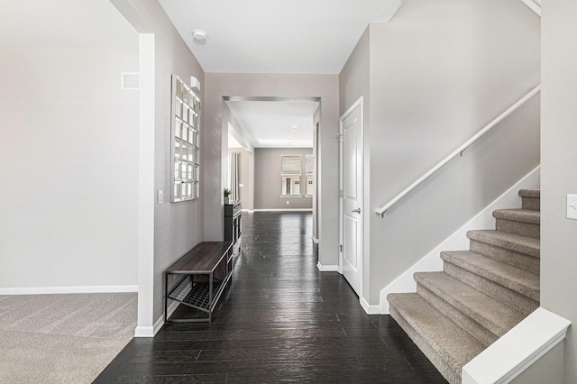 entryway featuring stairs, baseboards, and dark wood-type flooring