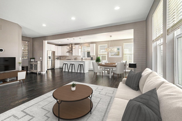 living area with a chandelier, recessed lighting, and dark wood-style flooring