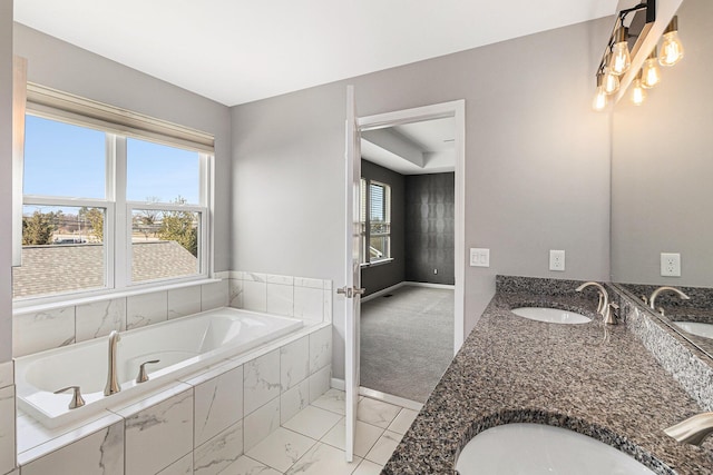 bathroom featuring a wealth of natural light, a sink, and a bath